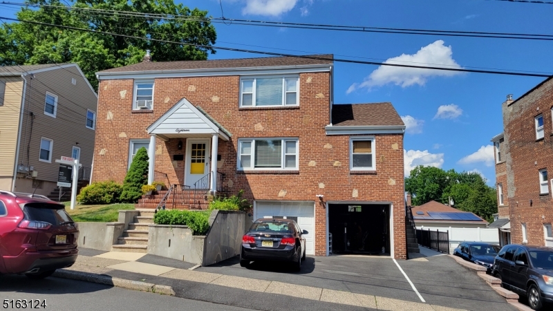 18 Howard Place, Unit 1 Nutley, NJ 07110 - Photo 1 of 17 a front view of a house with a yard