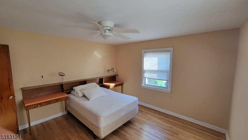 18 Howard Place, Unit 1 Nutley, NJ 07110 - Photo 11 of 17 a white bed sitting in a room next to a window