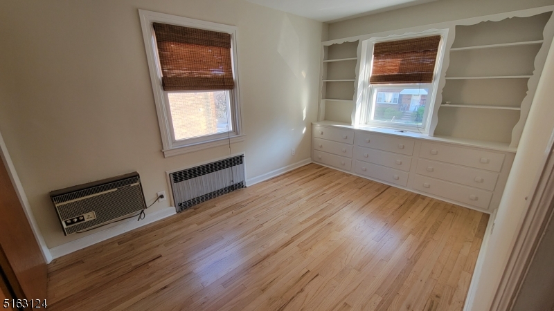 18 Howard Place, Unit 1 Nutley, NJ 07110 - Photo 13 of 17 a view of an empty room with wooden floor and a window