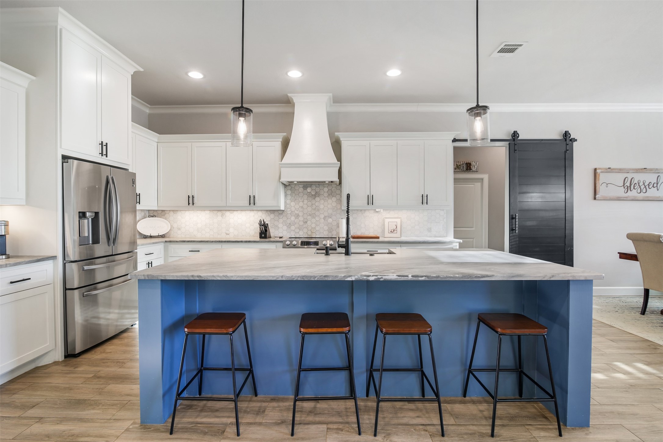 4219 Cross Cut Cleveland, TX 77328 - Photo 6 of 34 a kitchen with stainless steel appliances granite countertop a sink a stove a refrigerator and island with wooden floor