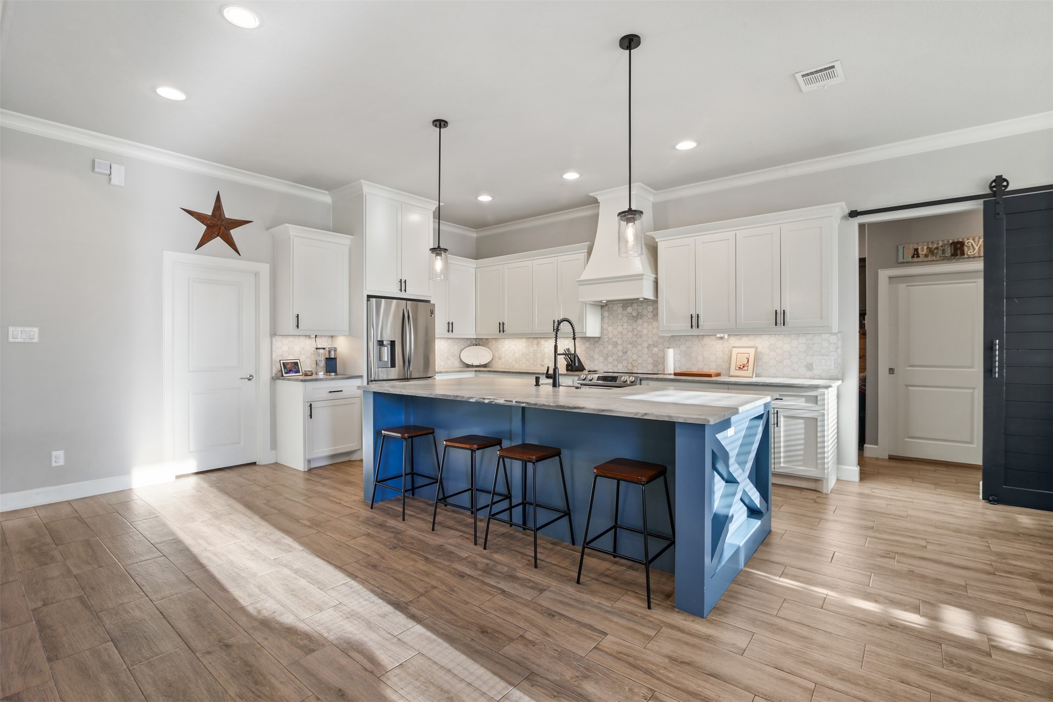 4219 Cross Cut Cleveland, TX 77328 - Photo 7 of 34 a large kitchen with cabinets chairs and wooden floor