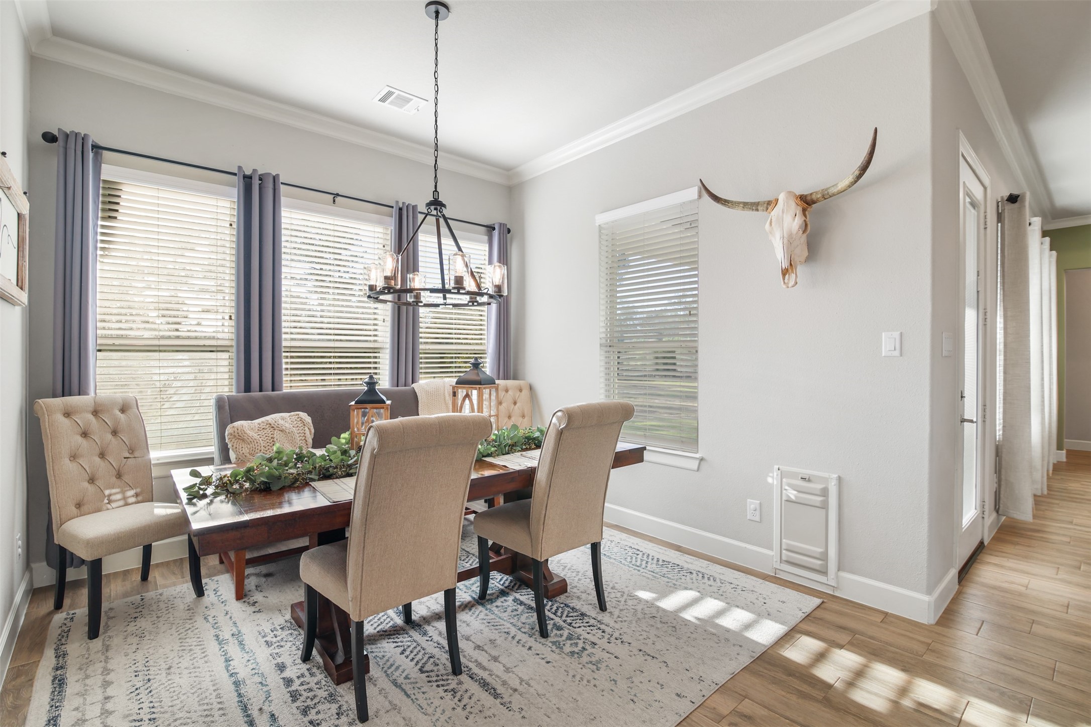 4219 Cross Cut Cleveland, TX 77328 - Photo 9 of 34 a dining room with furniture a chandelier and wooden floor