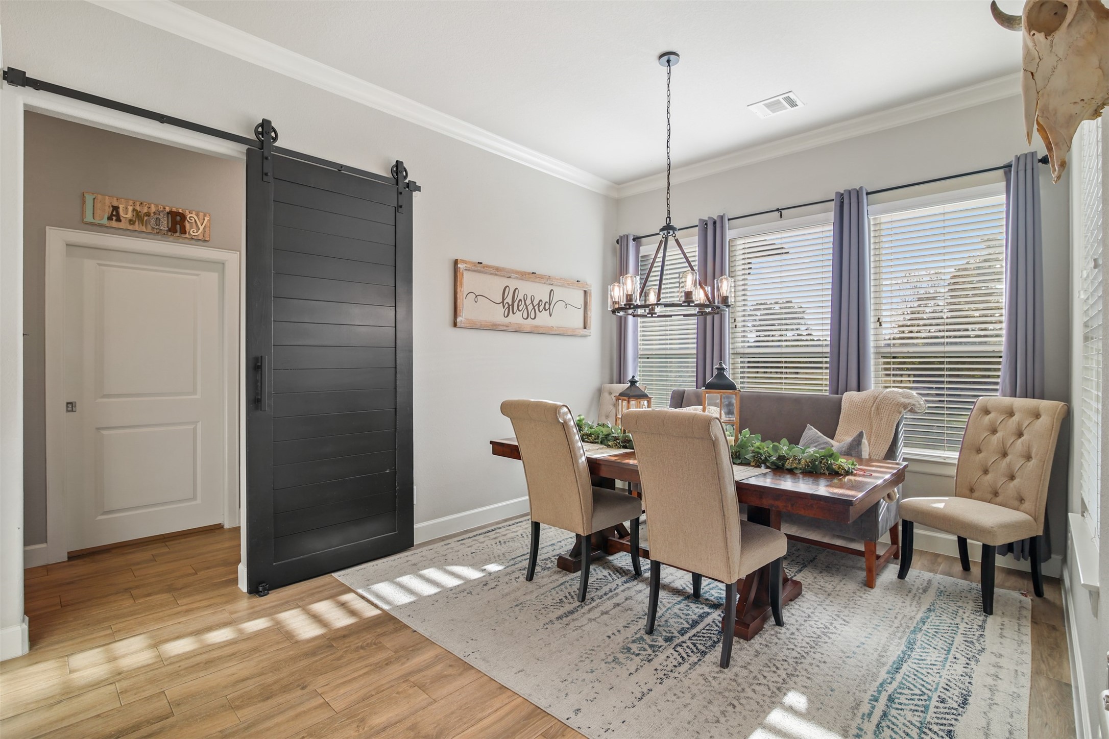 4219 Cross Cut Cleveland, TX 77328 - Photo 10 of 34 a dining room with furniture a chandelier and wooden floor