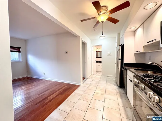 a view of a kitchen with a stove cabinets and wooden floor