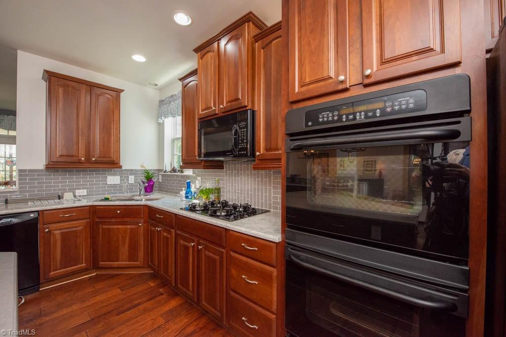 3084 Sycamore Point Trail High Point, NC 27265 - Photo 11 of 33 tile backsplash and quartz countertops are new