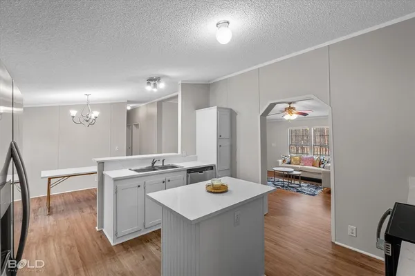 a open kitchen with sink cabinets and wooden floor
