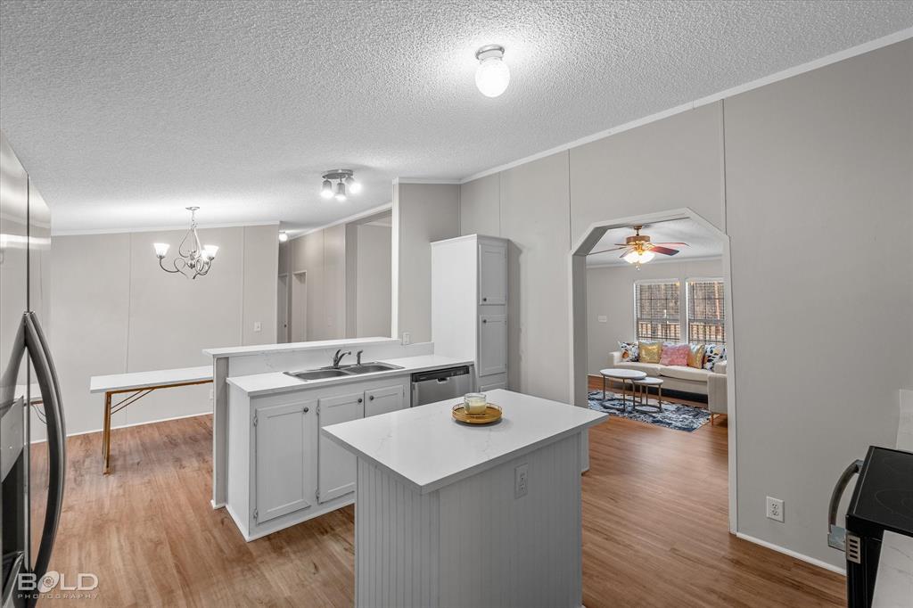 171 7 Pines Road Benton, LA 71006 - Photo 13 of 39 a open kitchen with sink cabinets and wooden floor