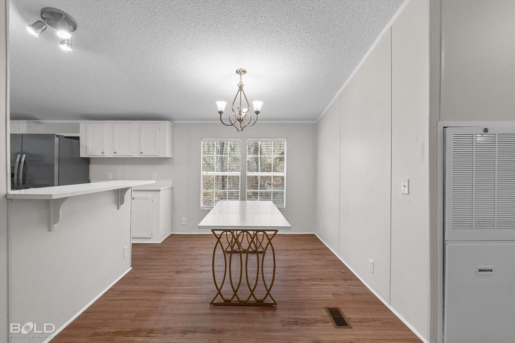 171 7 Pines Road Benton, LA 71006 - Photo 15 of 39 a view of a hallway with wooden floor and a kitchen