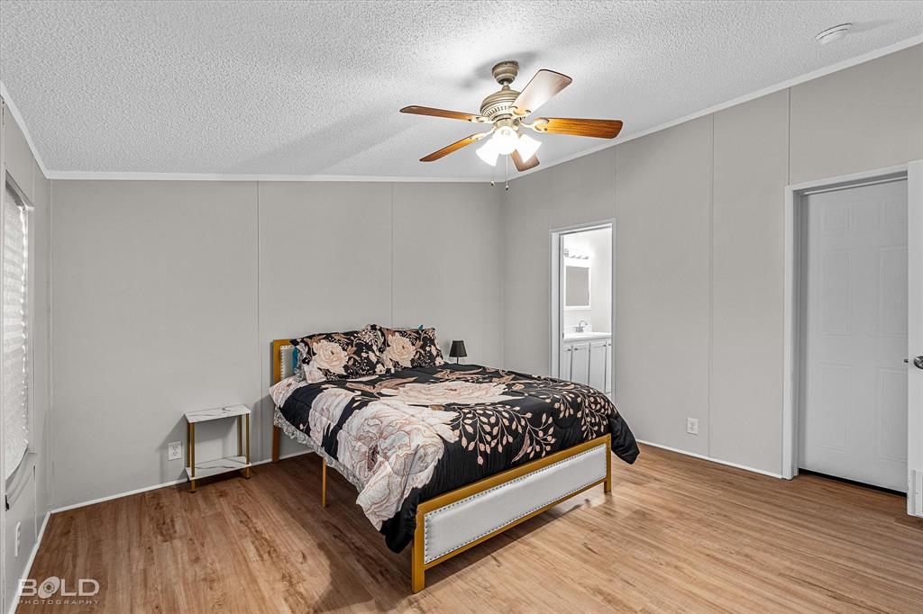 171 7 Pines Road Benton, LA 71006 - Photo 17 of 39 a bedroom with a bed and a chandelier