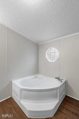 a spacious bathroom with a bathtub and chandelier