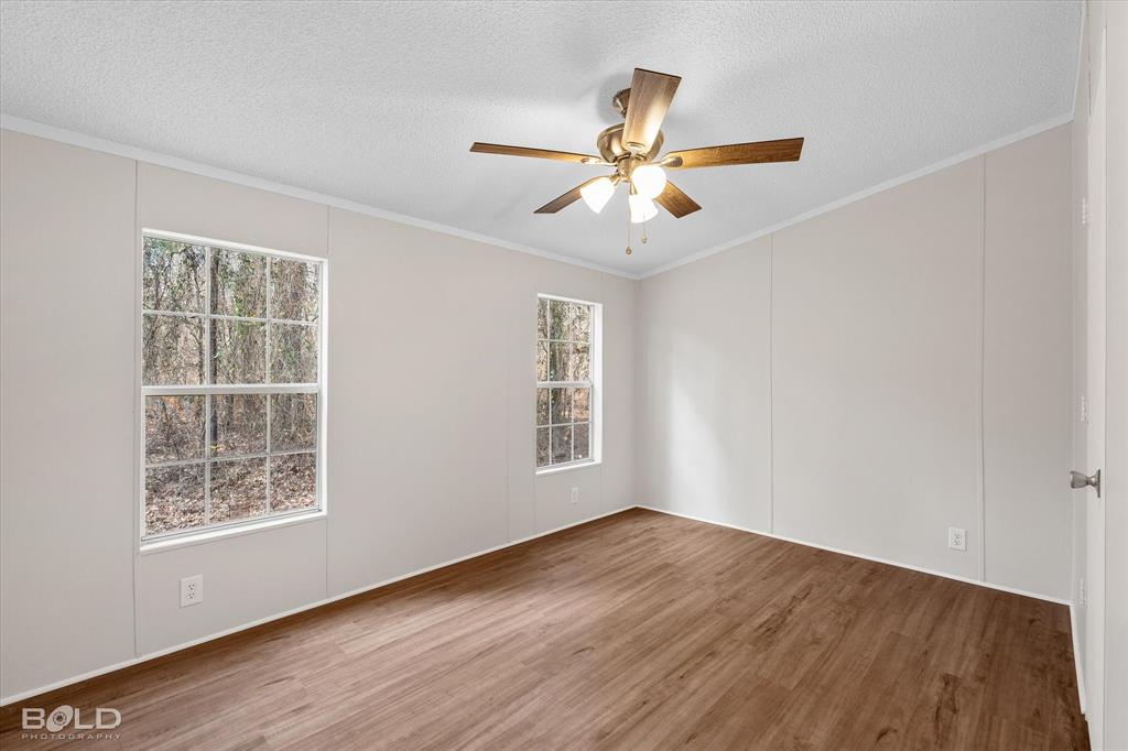 171 7 Pines Road Benton, LA 71006 - Photo 23 of 39 a view of an empty room with wooden floor and a window