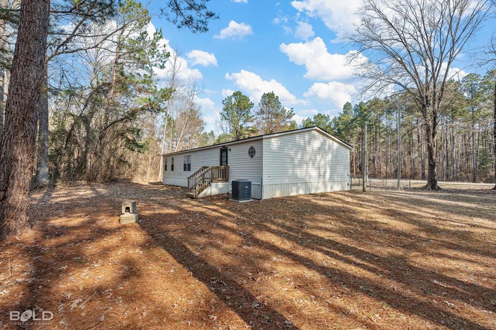 171 7 Pines Road Benton, LA 71006 - Photo 30 of 39 a view of a house with a snow in the yard