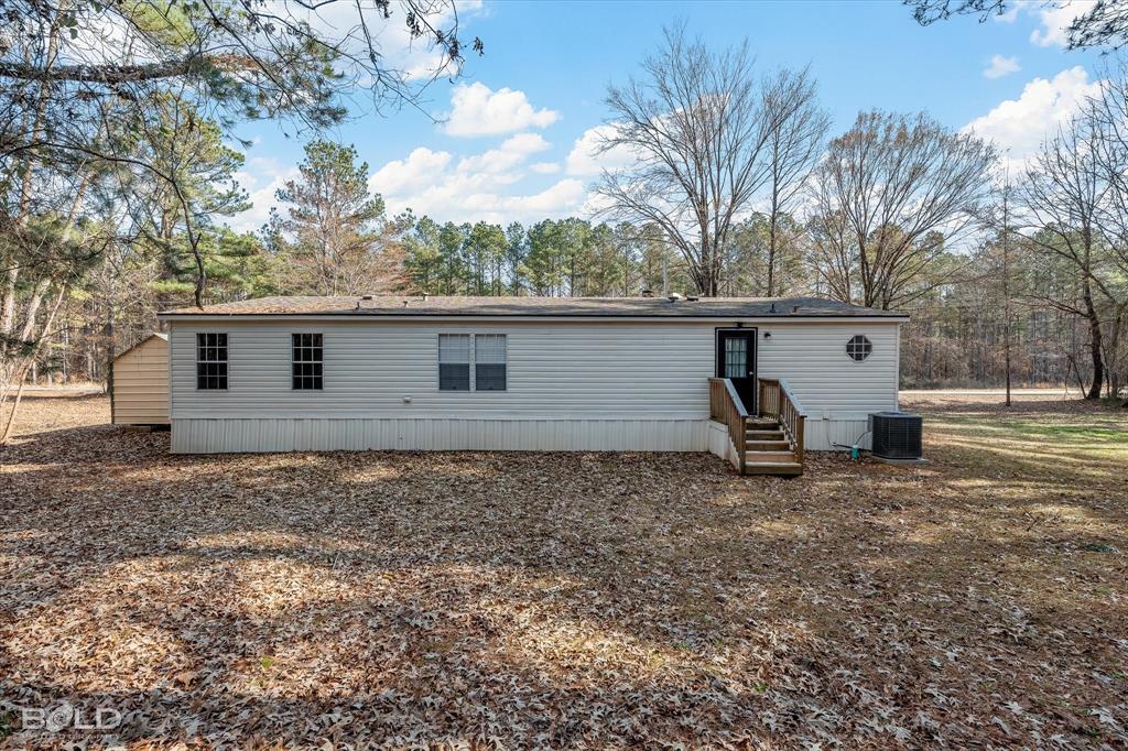 171 7 Pines Road Benton, LA 71006 - Photo 31 of 39 a backyard of a house with table and chairs