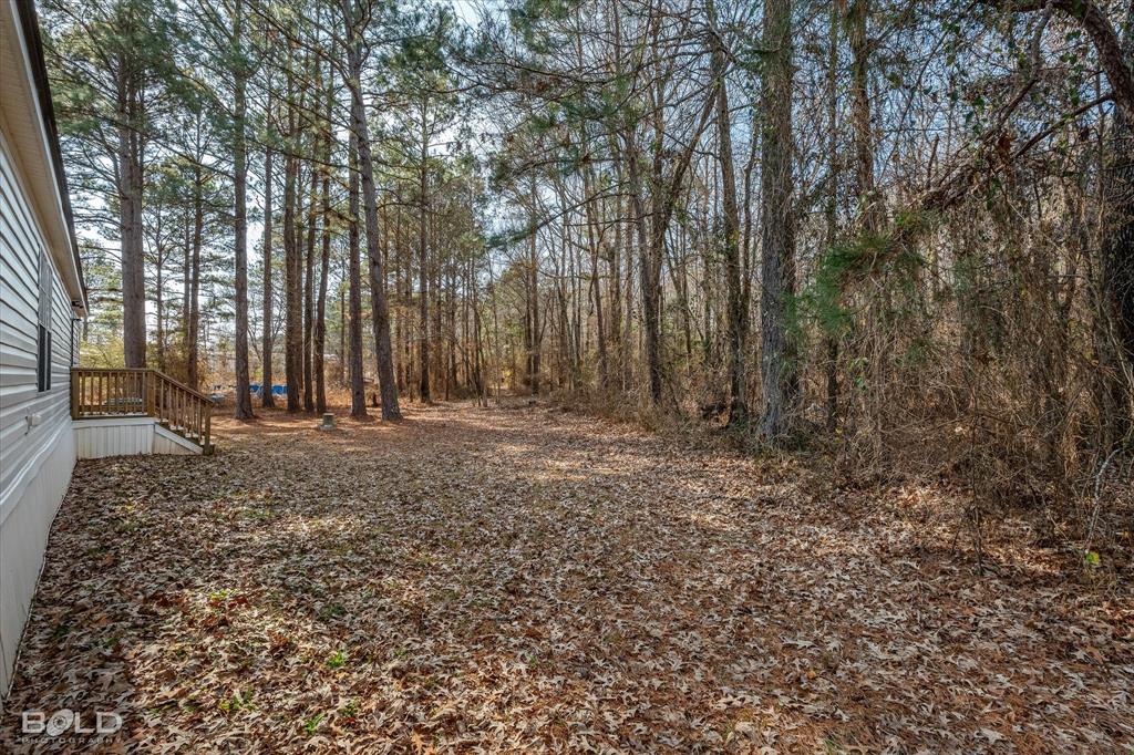 171 7 Pines Road Benton, LA 71006 - Photo 32 of 39 a view of outdoor space with deck and tree
