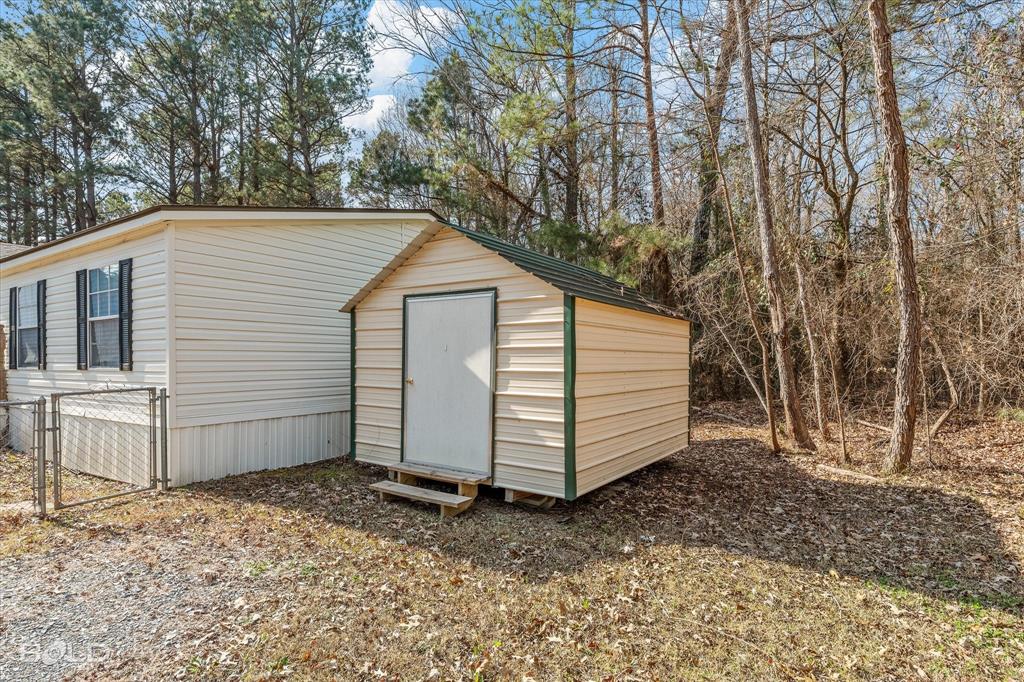 171 7 Pines Road Benton, LA 71006 - Photo 33 of 39 a view of a house with a yard and wooden fence