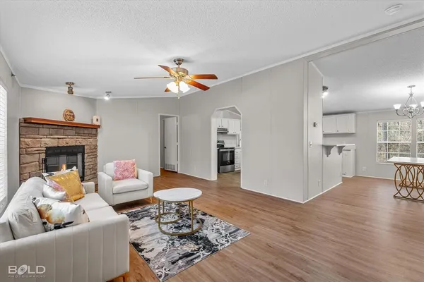 a living room with furniture and a wooden floor