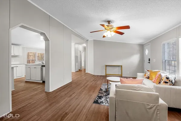 a bedroom with furniture and wooden floor