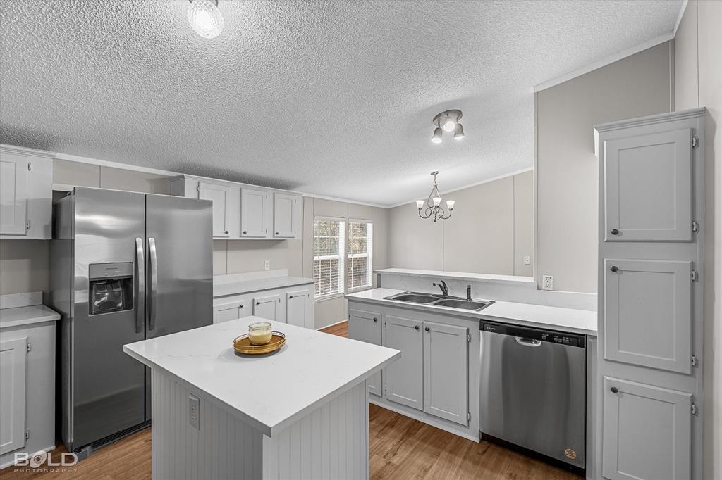 171 7 Pines Road Benton, LA 71006 - Photo 10 of 39 a kitchen with stainless steel appliances granite countertop a sink stove and refrigerator