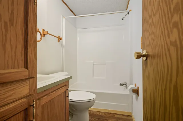 a view of an entryway with wooden floor