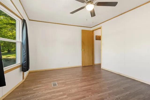 a view of empty room with wooden walls