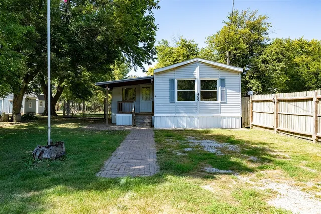 a backyard of a house with table and chairs