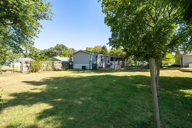 a house view with swimming pool in front of it