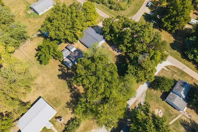 a view of a swimming pool with a yard and plants