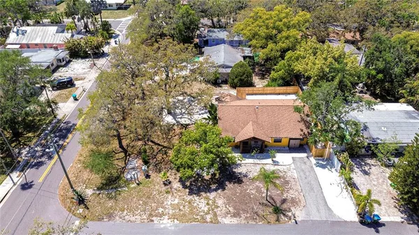 an aerial view of a house with a yard basket ball court and outdoor seating