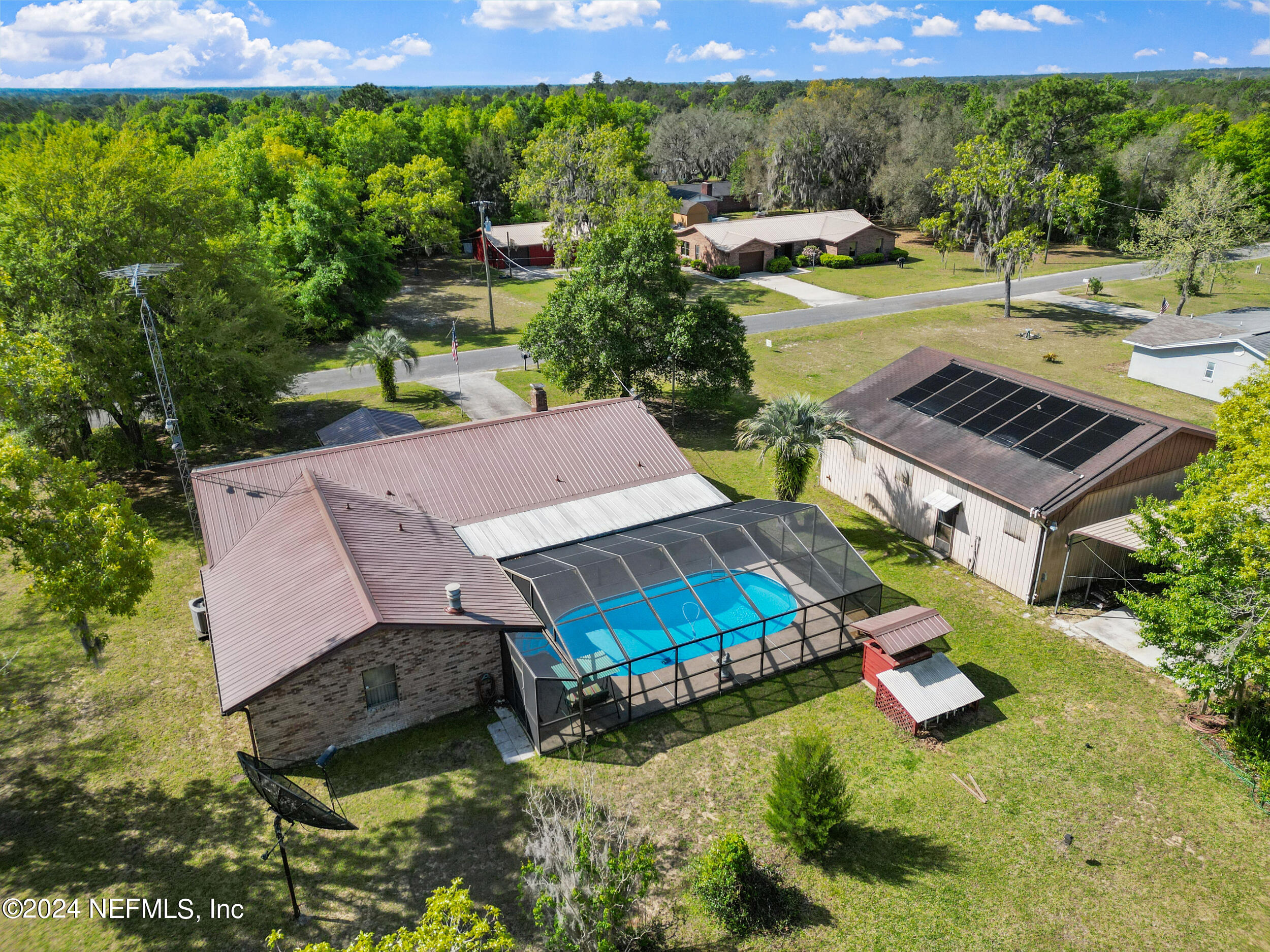 an aerial view of a house with garden space and street view