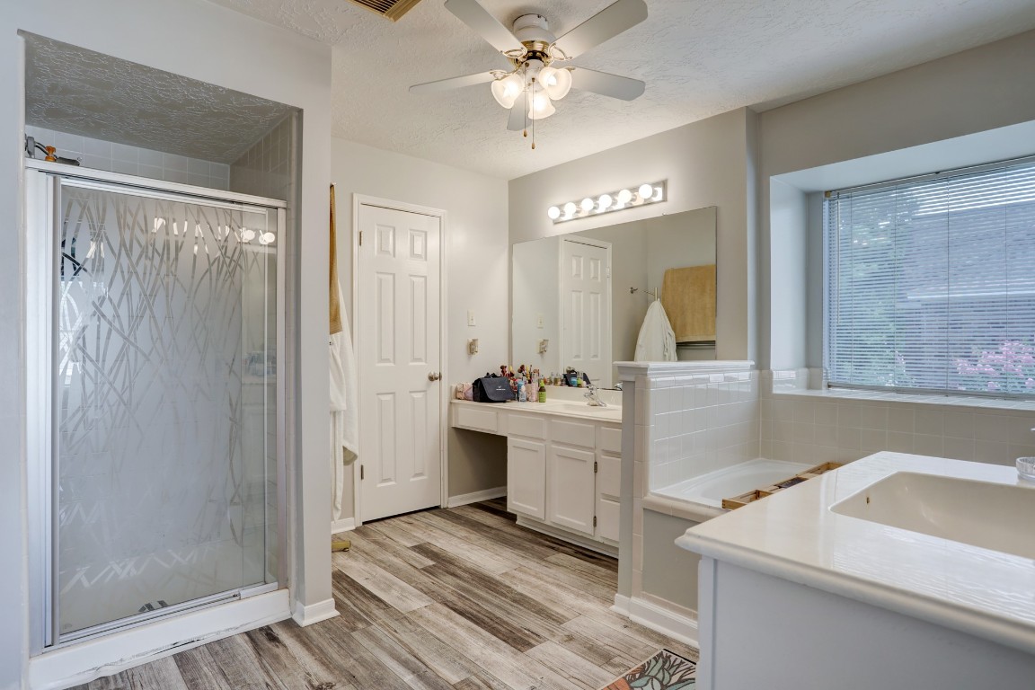 1611 Falcon Ridge Boulevard Friendswood, TX 77546 - Photo 9 of 11 View of the primary bathroom, has a separate tub and shower, along with his and her vanities.
