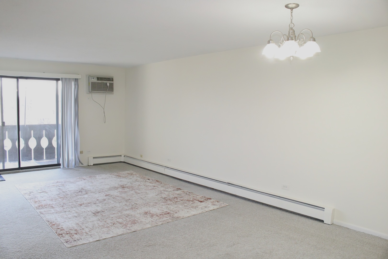 2 Timber Lane, Unit 17 Vernon Hills, IL 60061 - Photo 22 of 28 an empty room with a chandelier fan and windows