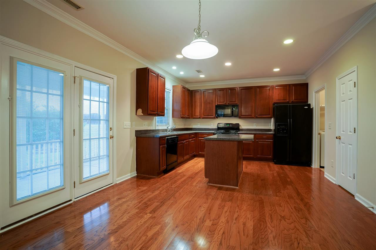 1517 Roaring Rapids Road Raleigh, NC 27610 - Photo 6 of 28 What a kitchen! Open and airy with a center island, new wood flooring, and open to the spacious family room with fireplace and gas logs. Kitchen
