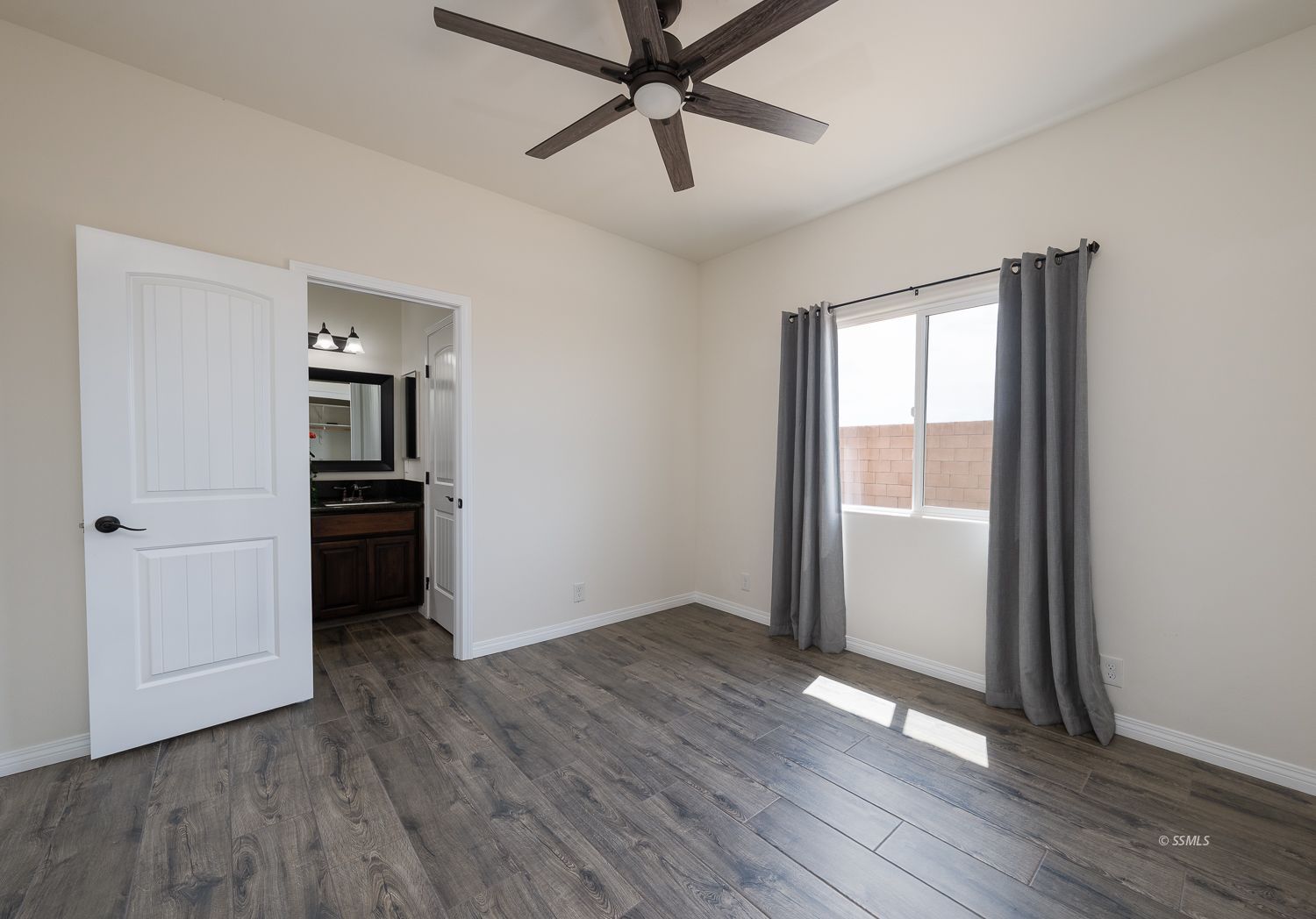 133 Rancho Del Cerro Ridgecrest, CA 93555 - Photo 34 of 50 wooden floor in an empty room with a kitchen