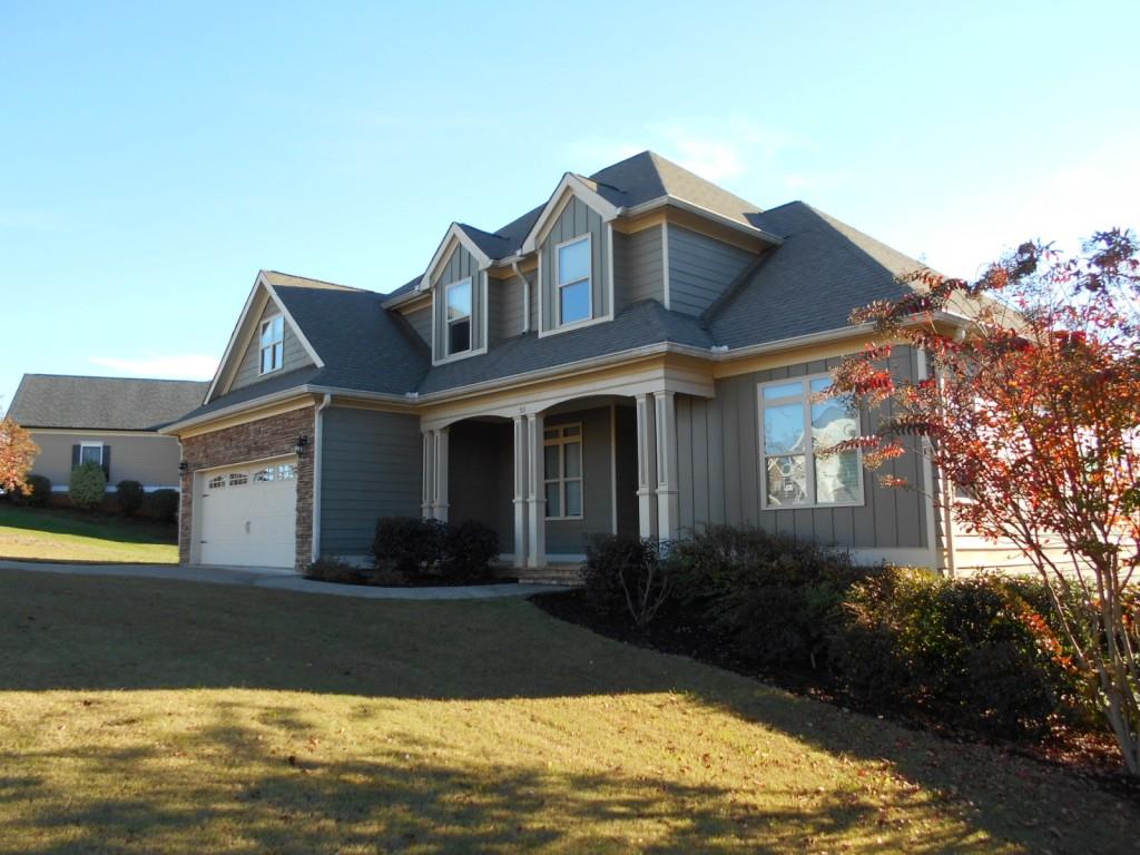 a front view of a house with garden
