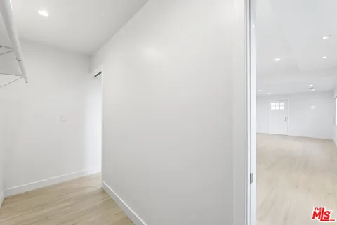 a view of a hallway with wooden floor