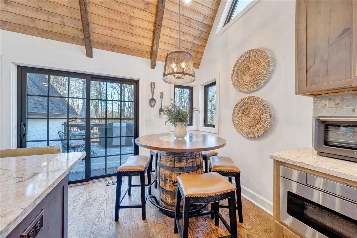 3851 Joppa Mill Road Moneta, VA 24121 - Photo 38 of 104 a view of a dining room with furniture a chandelier and wooden floor
