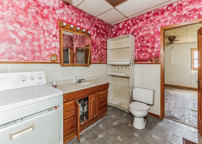 309 North 9th Street Rochelle, IL 61068 - Photo 23 of 23 a bathroom with a toilet sink and mirror