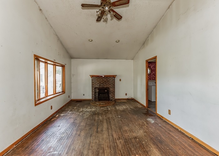 309 North 9th Street Rochelle, IL 61068 - Photo 8 of 23 a view of an empty room with a fireplace and a window