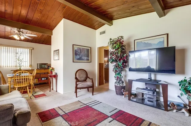 a room with painting on the wall and a potted plant