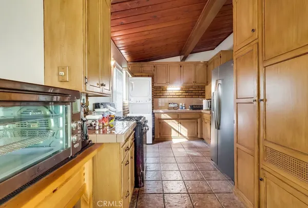 a kitchen with granite countertop a sink and a stove