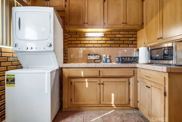 a bathroom with a granite countertop sink a toilet and shower