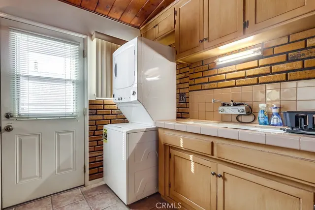 a bathroom with a granite countertop sink mirror vanity and toilet
