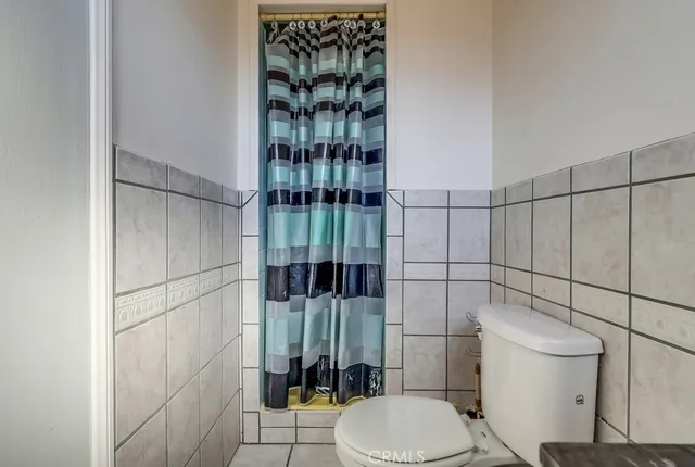 a view of a backyard with swimming pool and sitting area