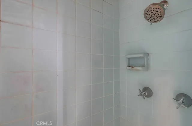 a view of a backyard with table and chairs and potted plants