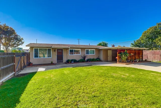 a view of a house with a yard and a table and chairs
