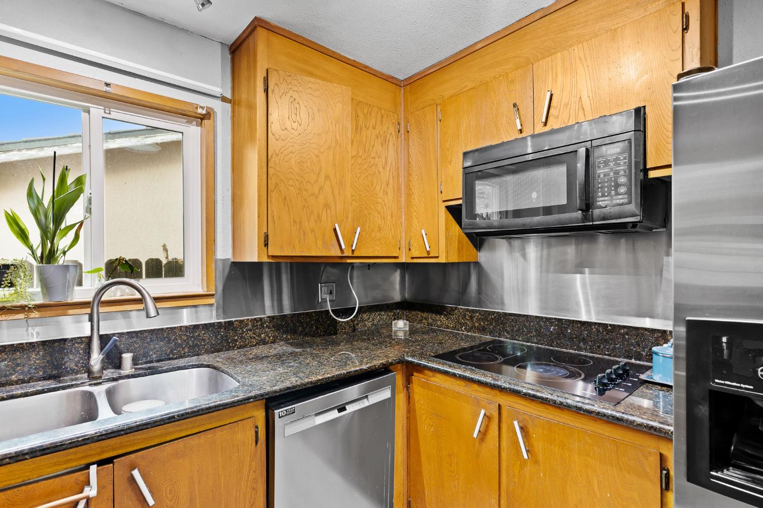 10825 Walnutwood Way Rancho Cordova, CA 95670 - Photo 11 of 34 a kitchen with a sink stove and microwave