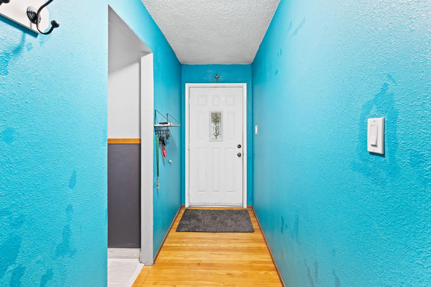 10825 Walnutwood Way Rancho Cordova, CA 95670 - Photo 14 of 34 a view of a hallway with wooden floor and a bathroom