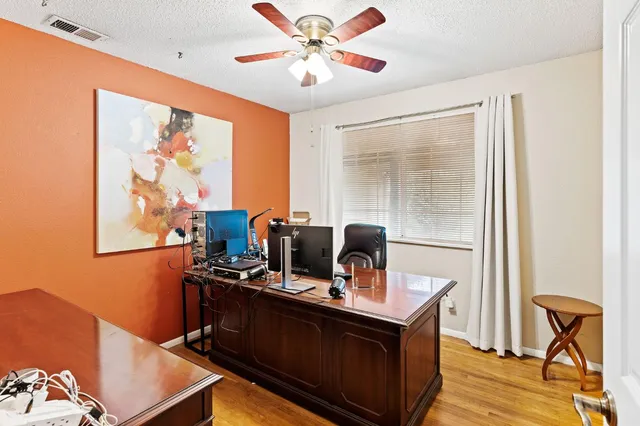 a view of workspace with wooden floor windows