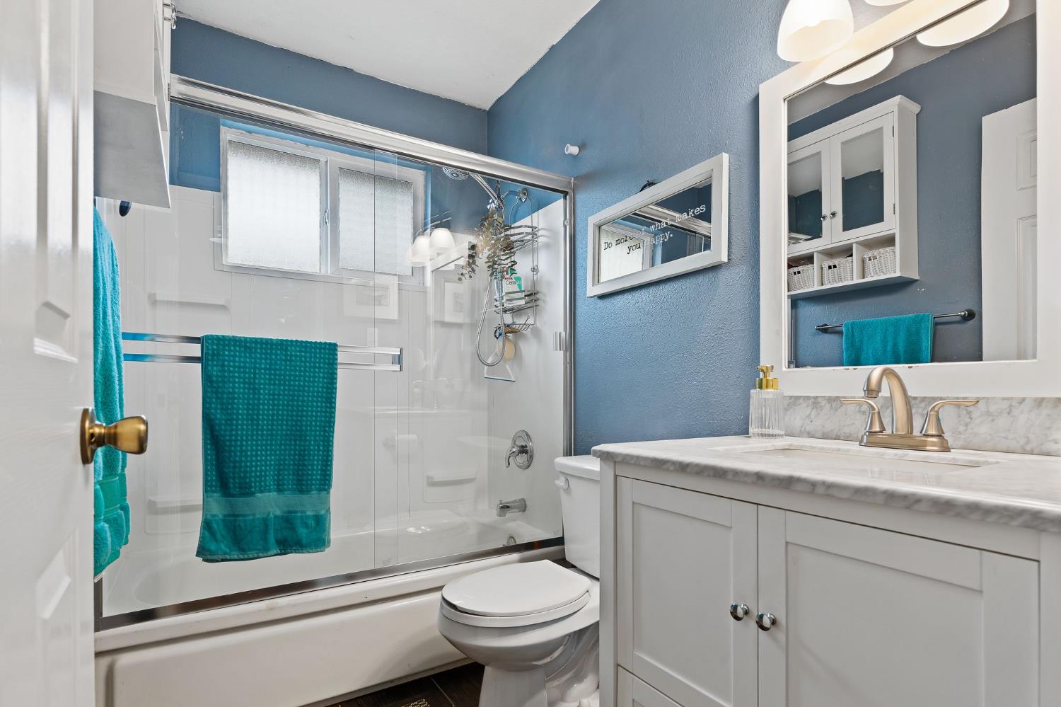 10825 Walnutwood Way Rancho Cordova, CA 95670 - Photo 17 of 34 a bathroom with a granite countertop toilet sink and mirror