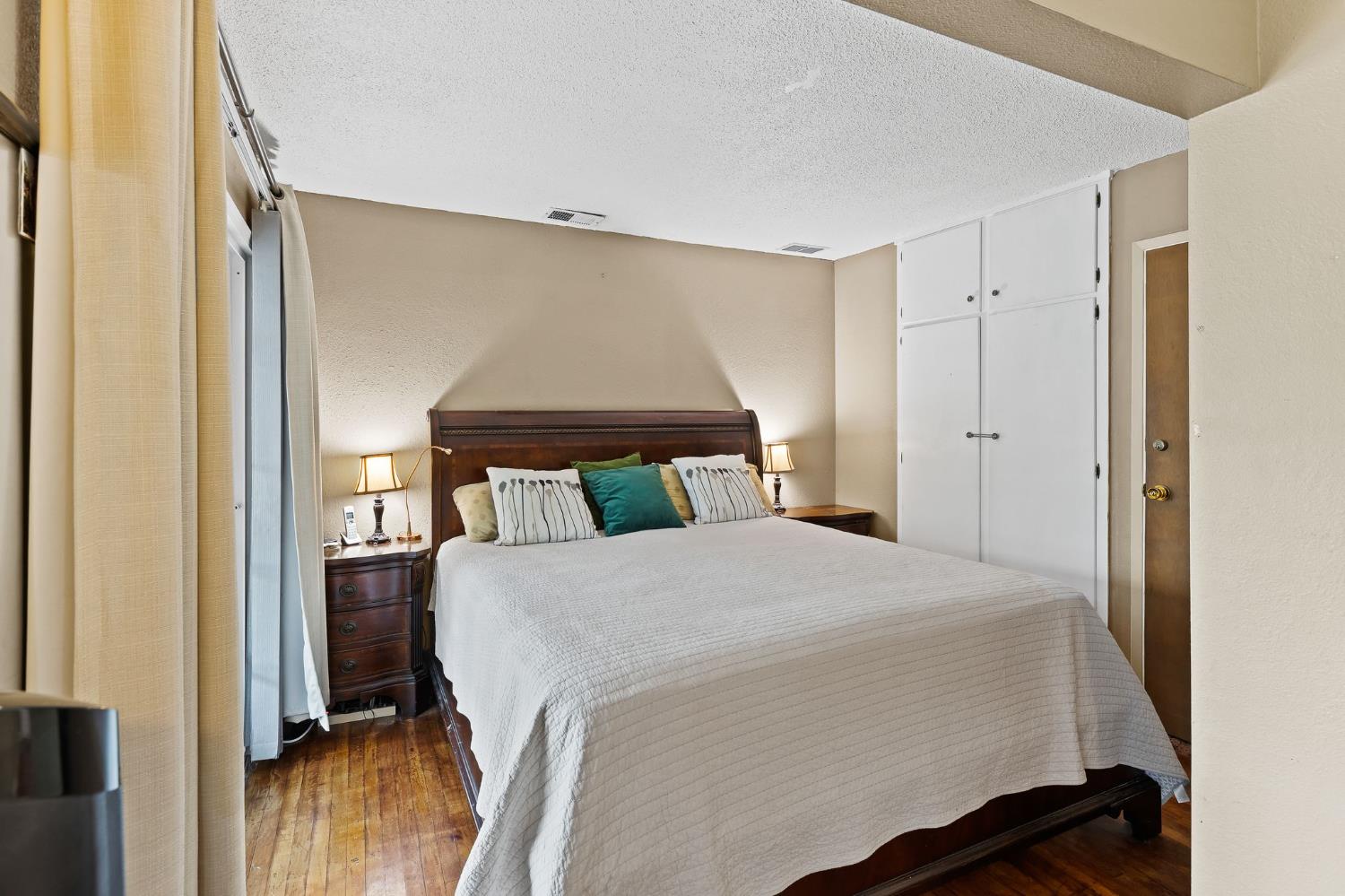 10825 Walnutwood Way Rancho Cordova, CA 95670 - Photo 21 of 34 a bedroom with a bed and wooden floor